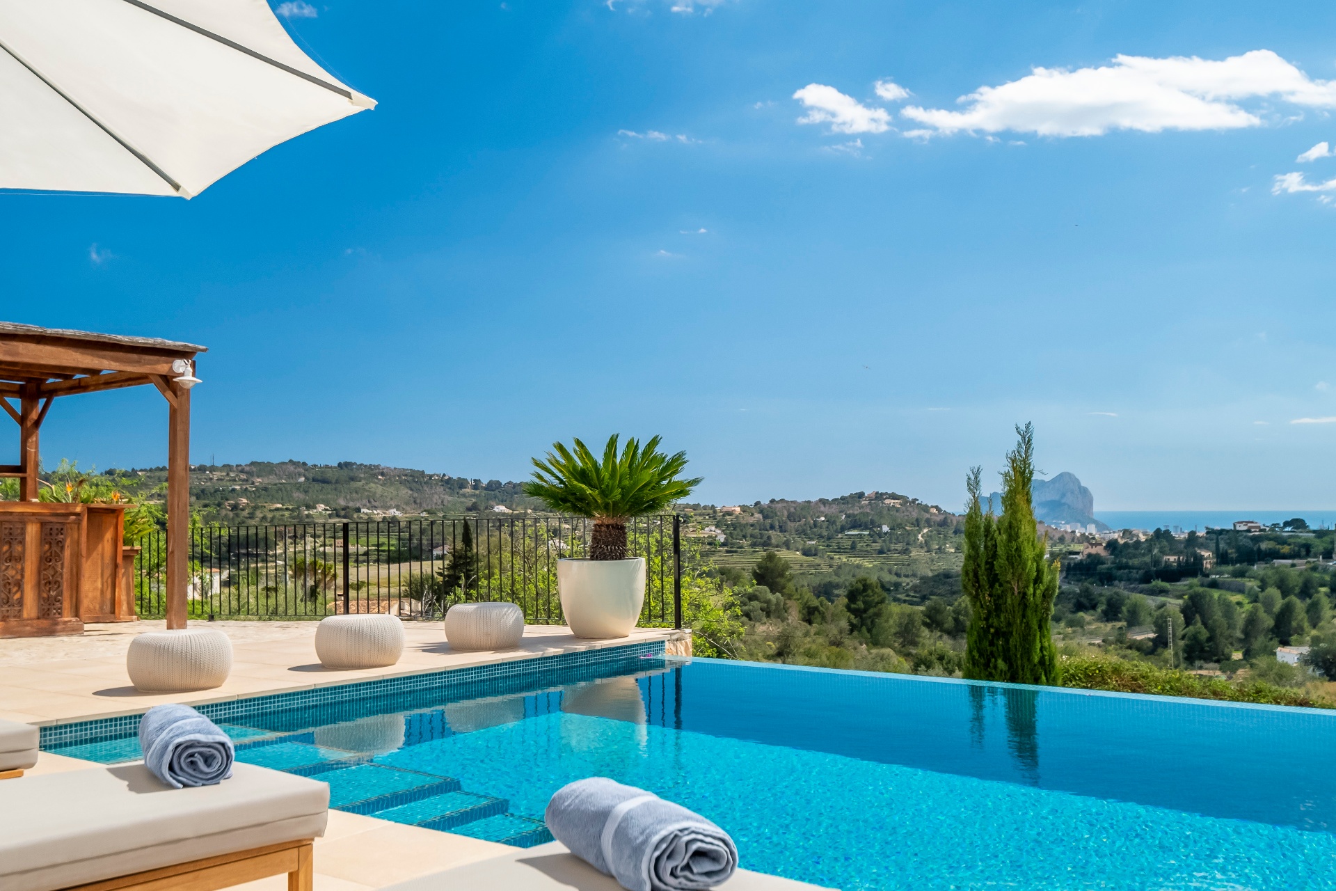 Infinity pool overlooking Mediterranean coast and mountains