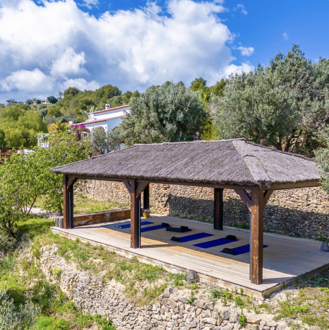 Outdoor yoga pavilion surrounded by nature