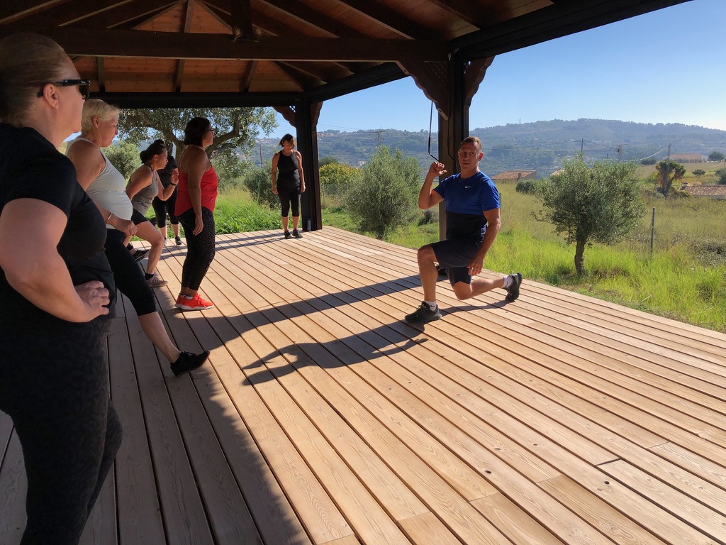 Fitness training session on wooden deck with mountain views